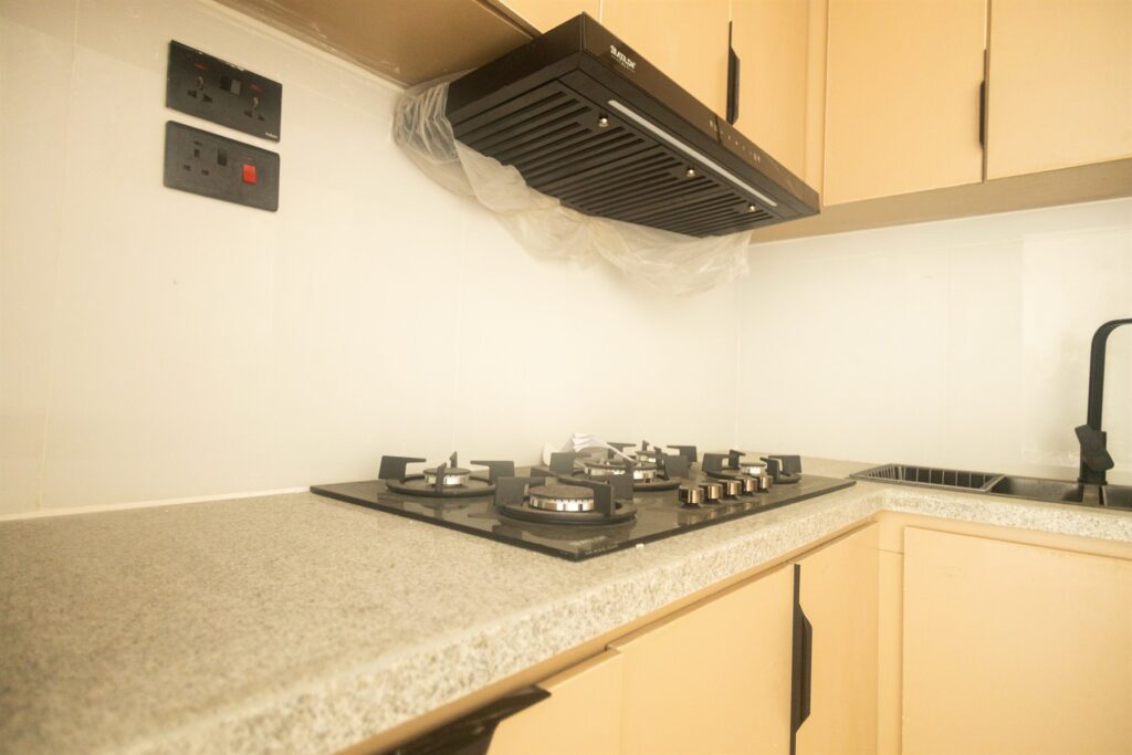 Brum Height 4: Kitchen hob and extractor above a stone worktop